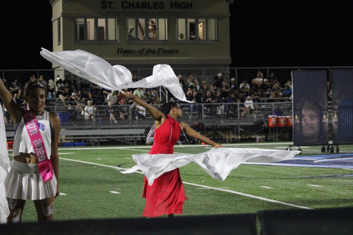 Anjelia Philogene gracefully moving her color guard flag.