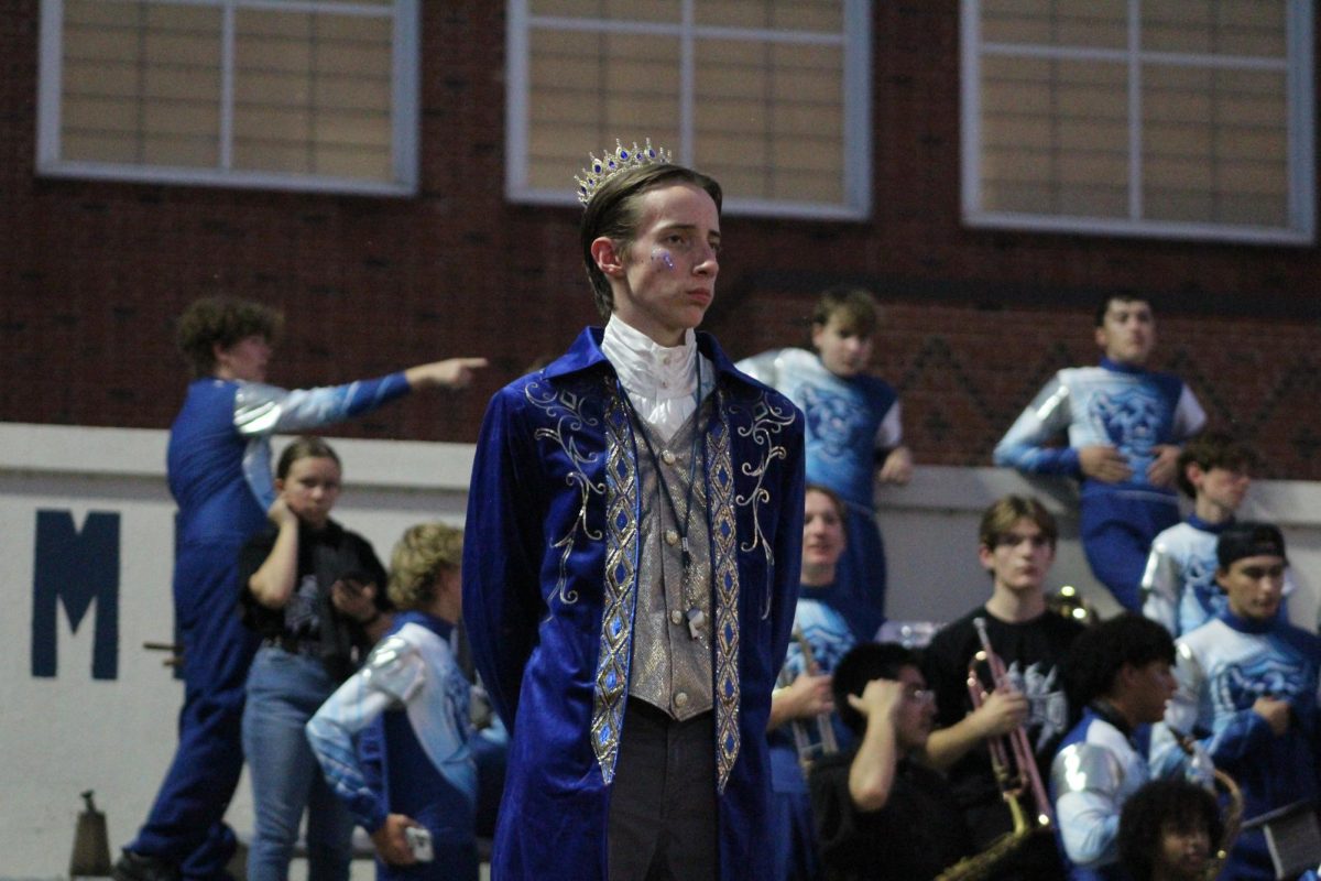 Maximilian Sheils, Drum Major, with his band behind him.