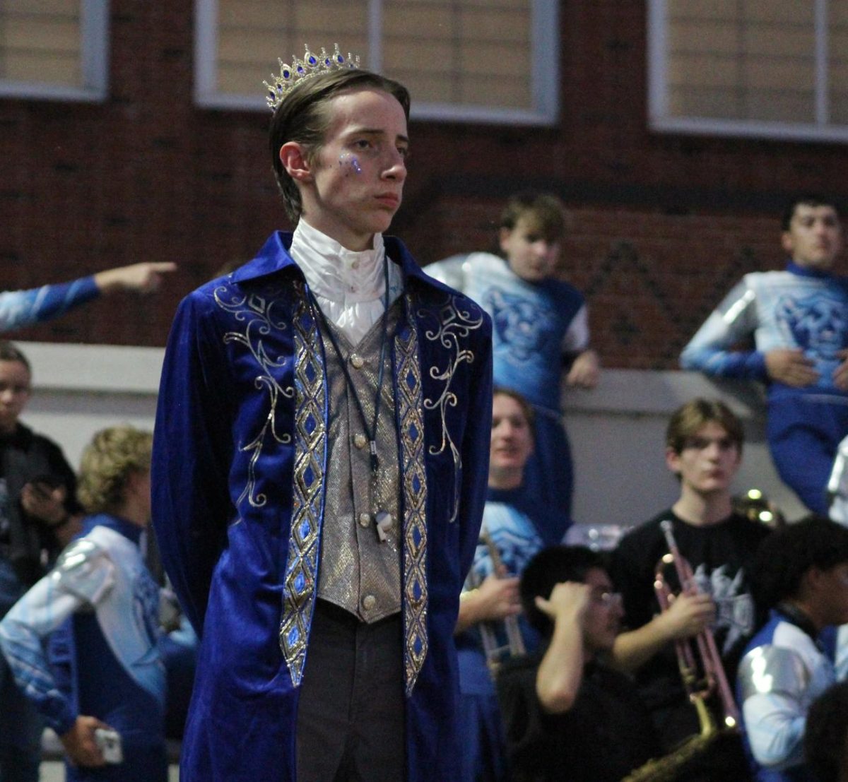 Maximilian Sheils, Drum Major, with his band behind him.
