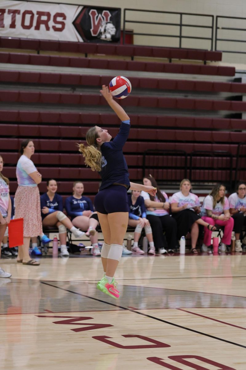 Rosie Kuegele serves the ball.