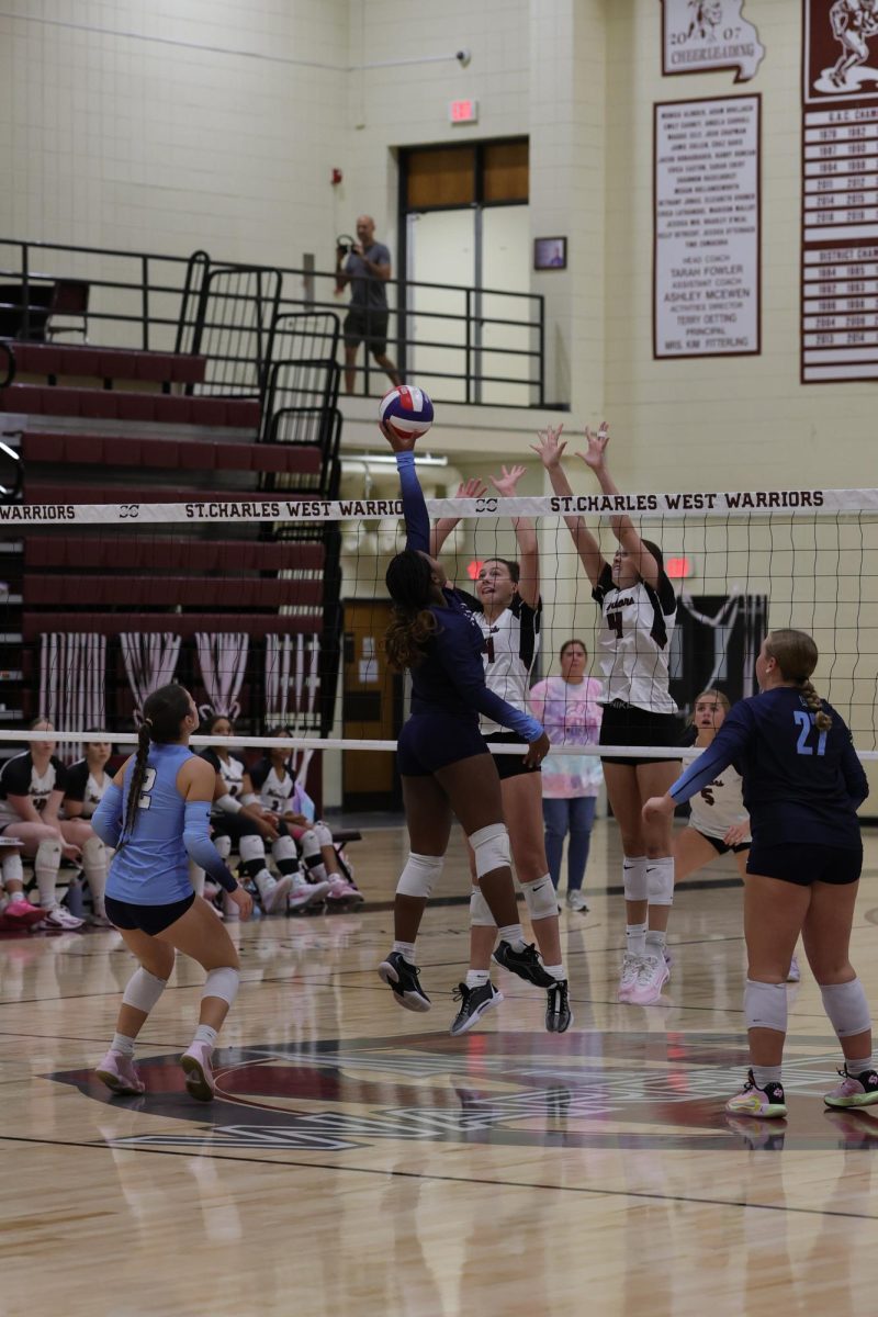 Preslie Philogene tips the ball over the block.