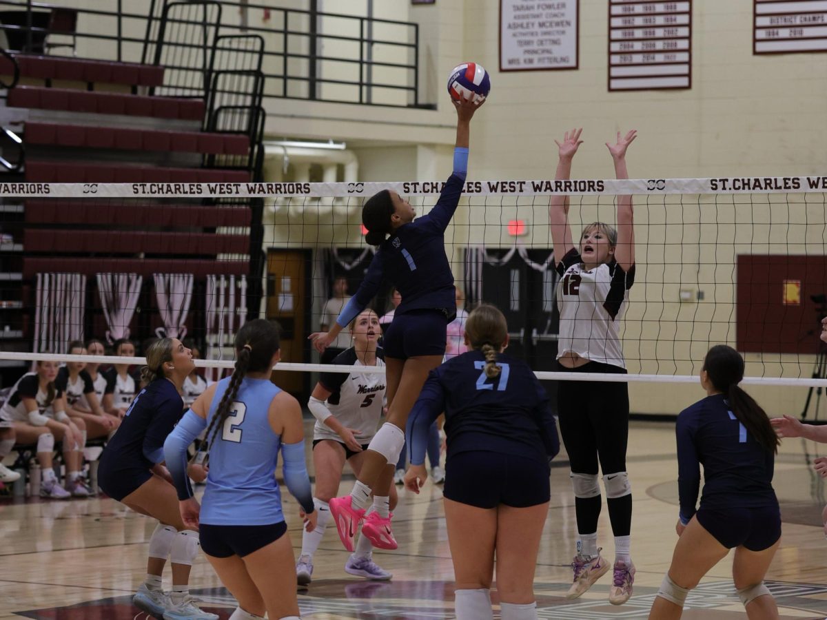 Malia Jones tips the ball back over the net.