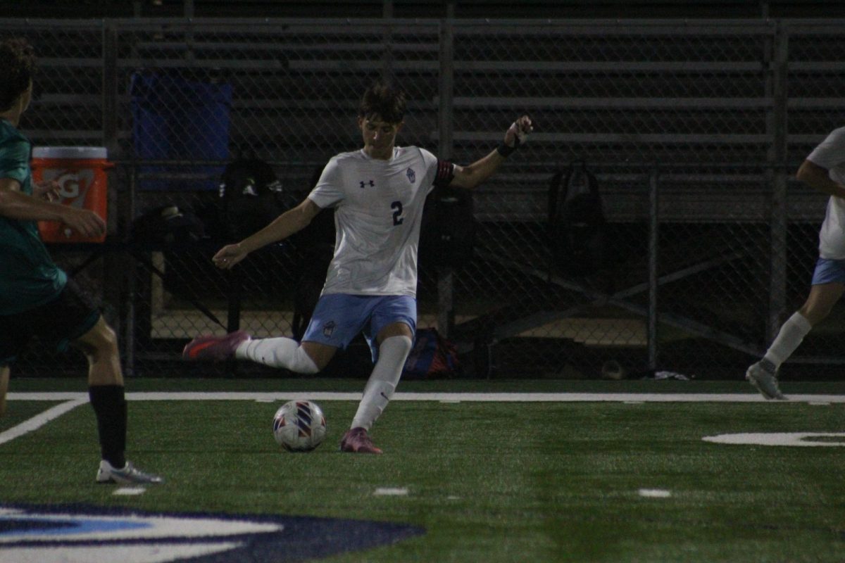 Jack Nemens kicking a ball.