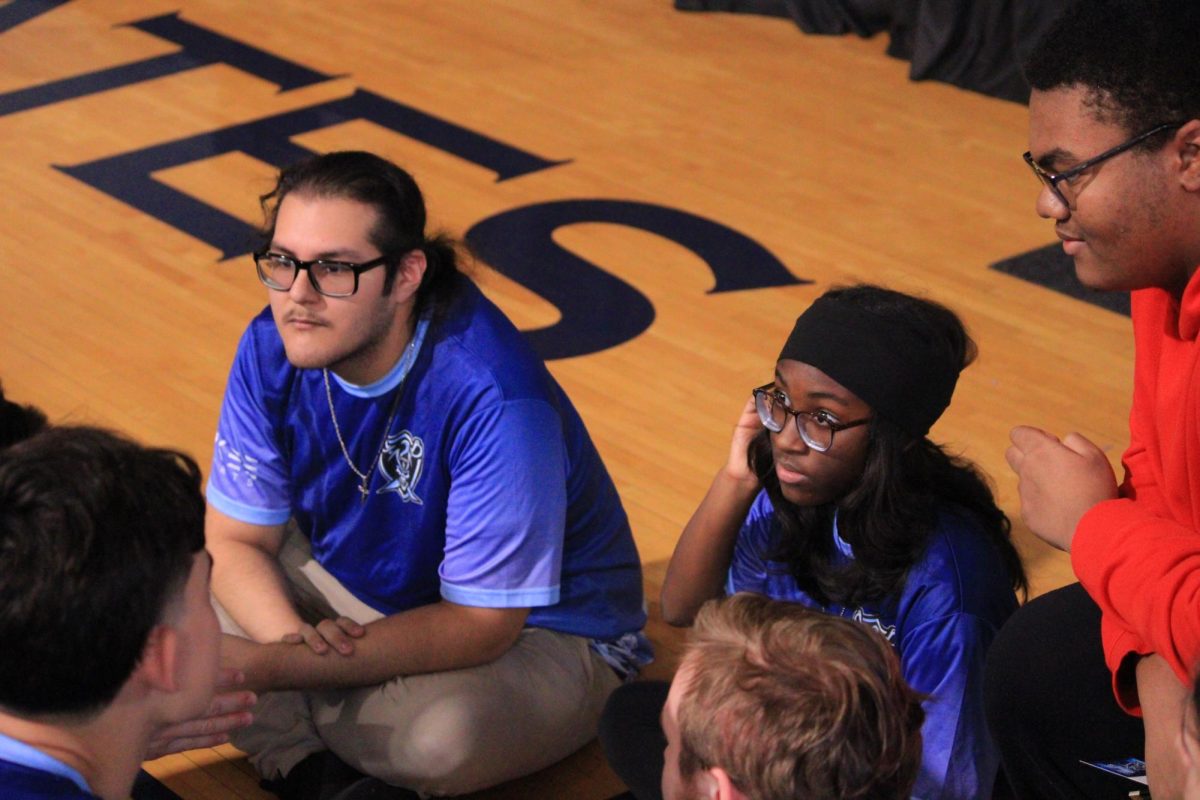 Ramon Navarrete and Chrisette Johnson listen to their teammates talk.