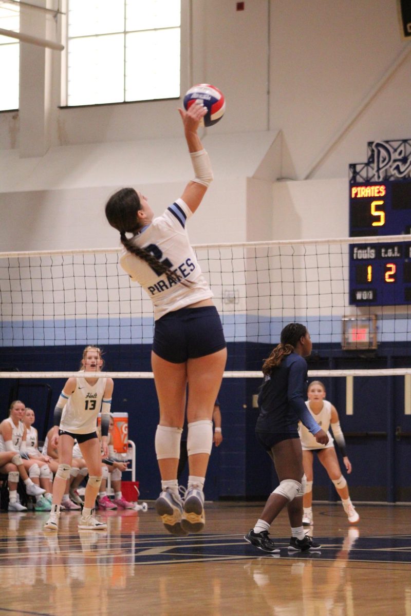 Lilly Bott serves the ball at Holt.