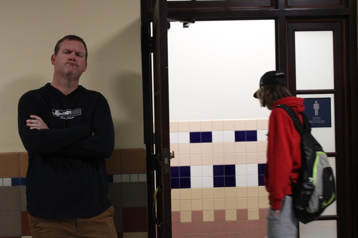 Social Studies teacher Bill Hippe monitors the Upper Commons boys bathroom.