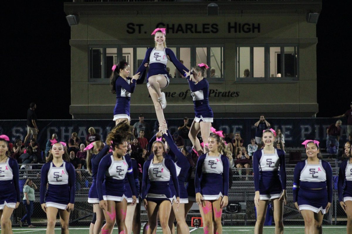 Allison Lindquist flies in a lib, assisted by Candice Hill and Gillian Phillips