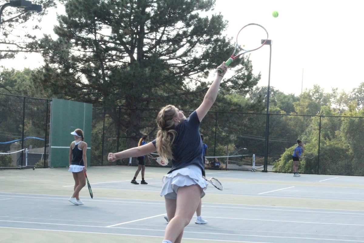 Caitlyn Buchholtz jumps after the ball.
