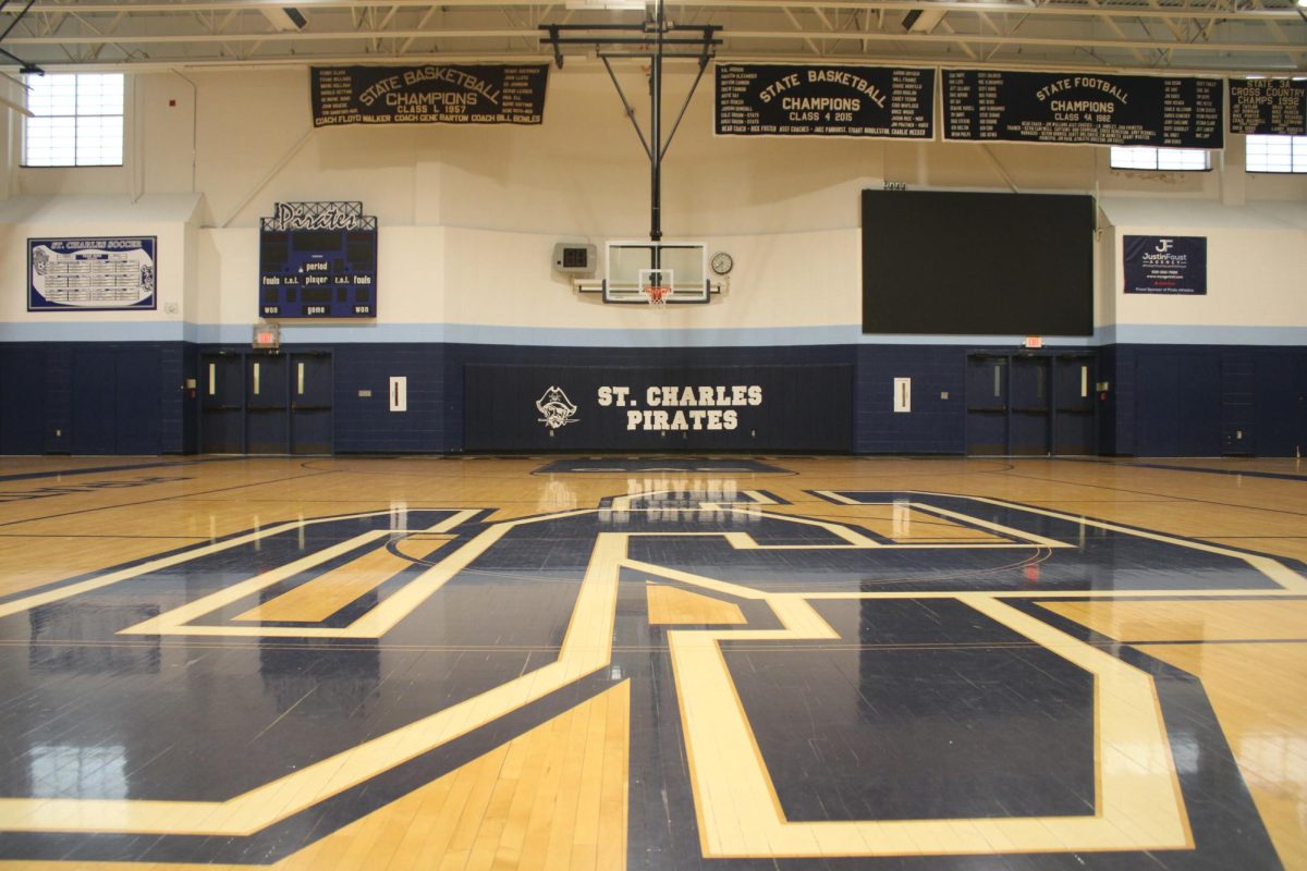 landscape shot coming from the center of the gym displaying the new big screen added to the west side of the gym.