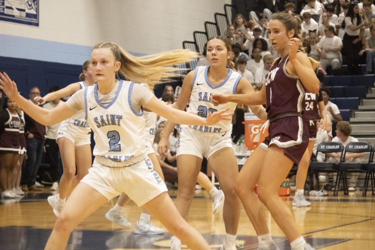 Brooklyn McAlister and Addie Tubbs shift around while defending St. Charles West. (Bailey Wetzler)