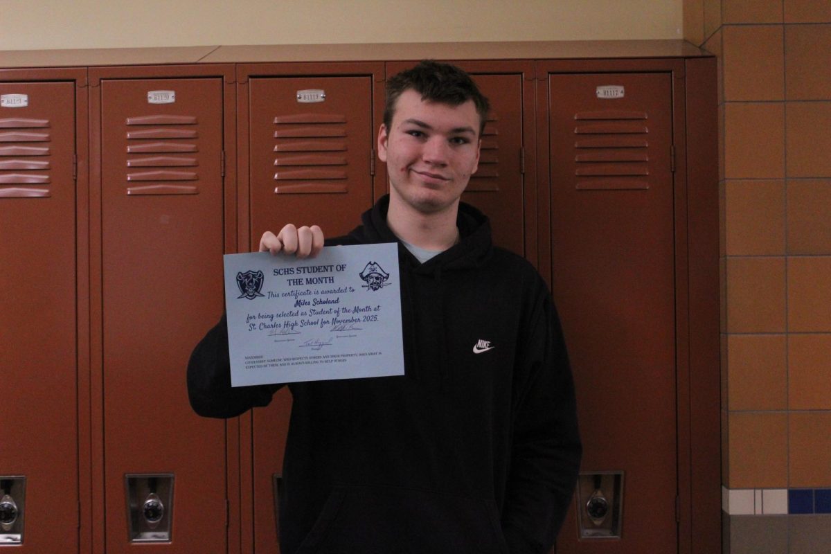 Miles Scholand holds his student of the month certificate.