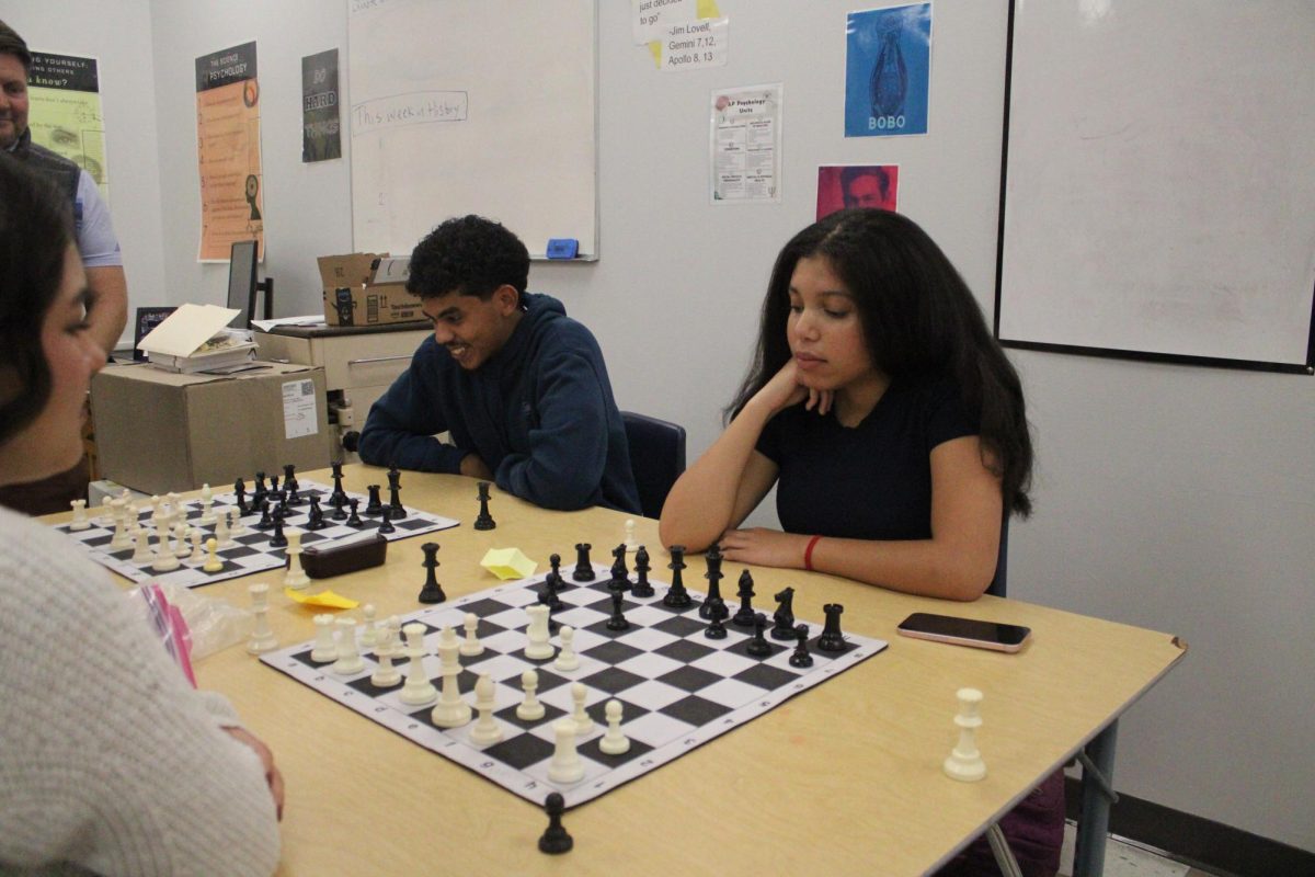Lana Usery and Kaua Reiss playing chess.