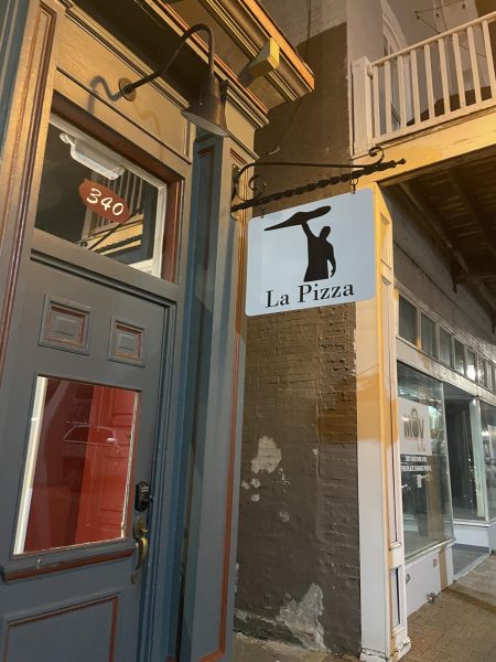 La Pizza's welcome sign sits above their door.