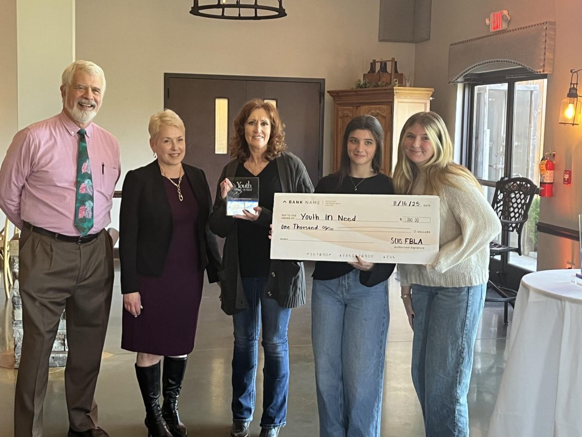 Wendy Kirchhofer, Isabelle Eaton and Caitlyn Buchholtz present Youth In Need with a $1000 check. (Wendy Kirchhofer)