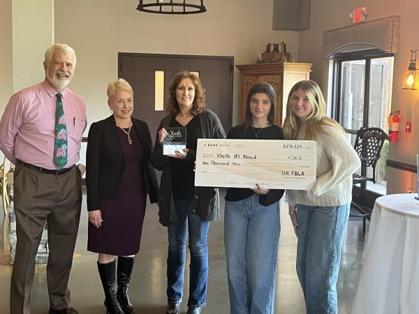 Wendy Kirchhofer, Isabelle Eaton and Caitlyn Buchholtz present Youth In Need with a $1000 check. (Wendy Kirchhofer)