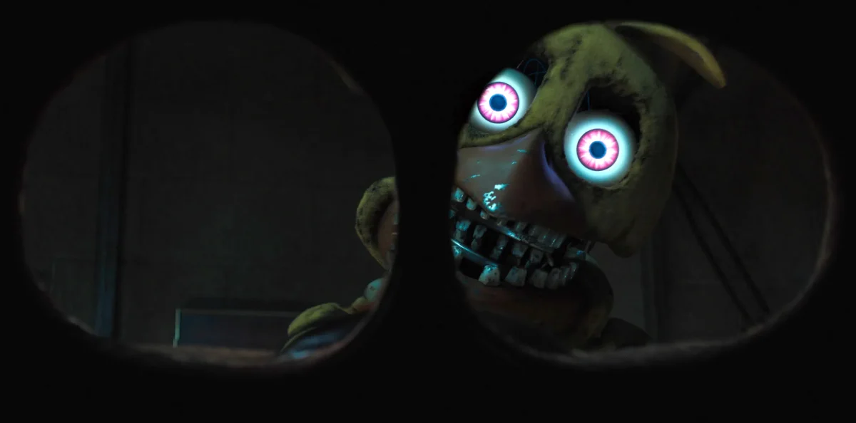 Withered Chica staring at the camera through a mask.