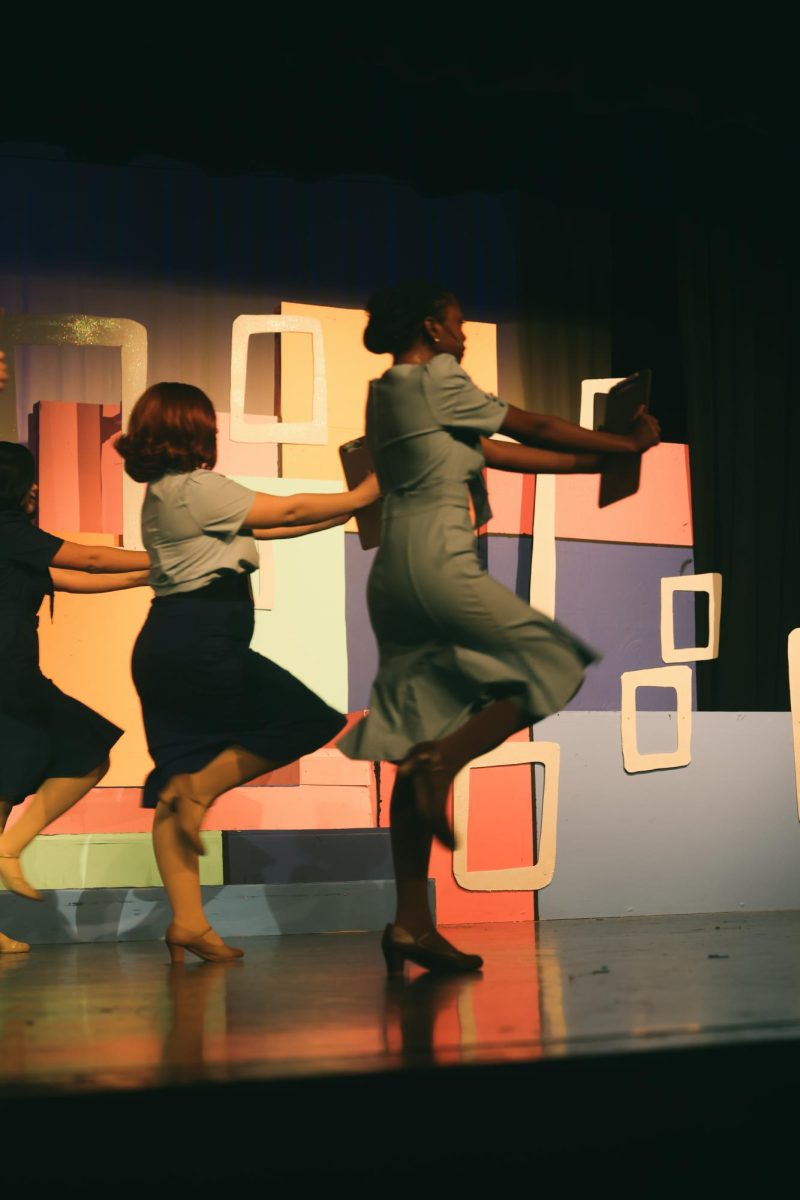 Lauren Murphy dances with the other secretaries.