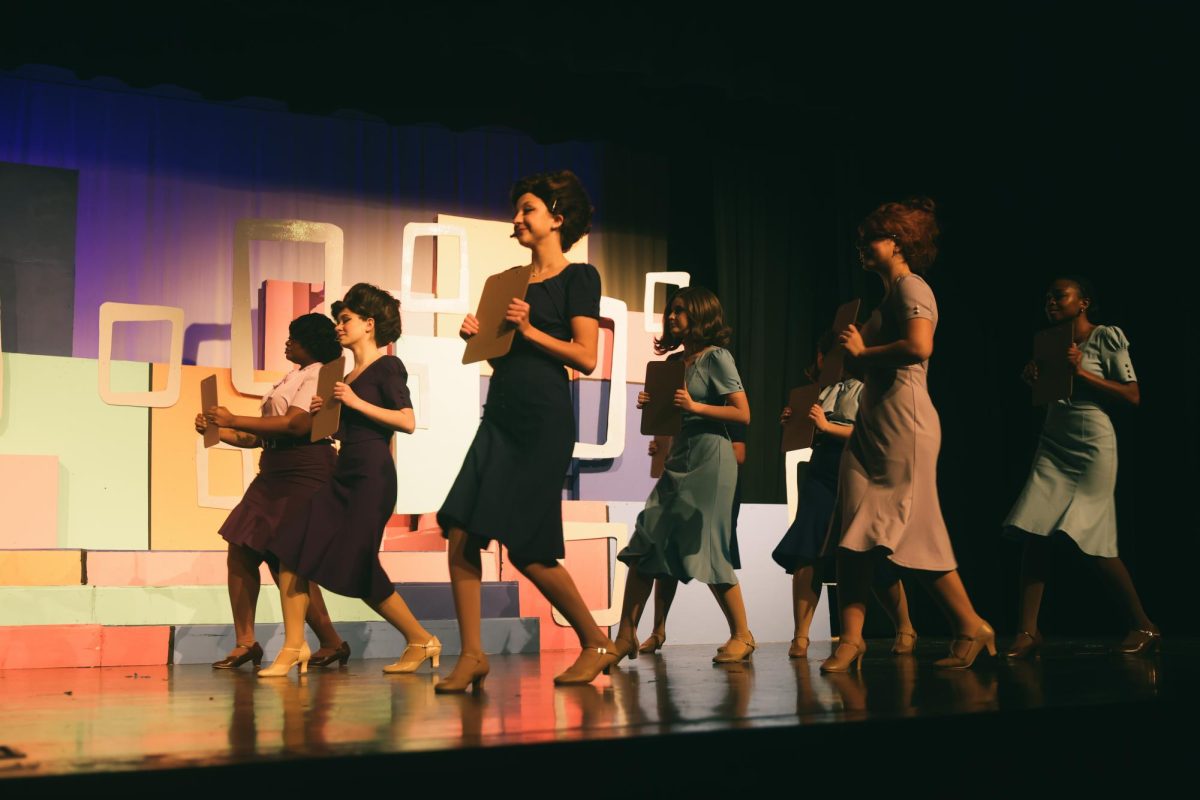 The secretaries dance together during How to Succeed in Business Without Really Trying.