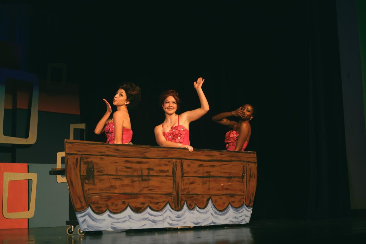 Lily Black, Charlotte Kulma, and Lauren Murphy wave goodbye to the audience and exit on the boat.