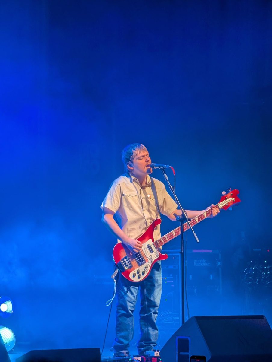 Jesse Golliher plays the bass and sings during The Runarounds concert.