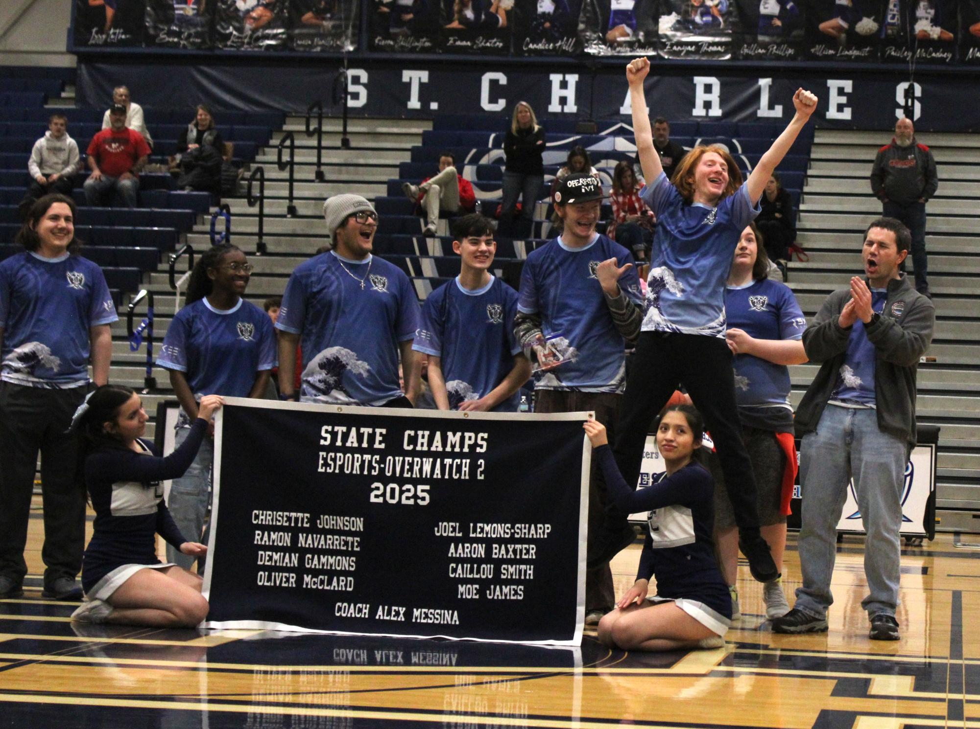 Esports team jumps for joy after receiving the state banner during Senior Night February 20th.