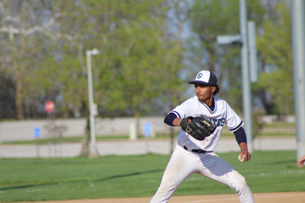 Junior Matthew Robertson throws the ball to the hitter.