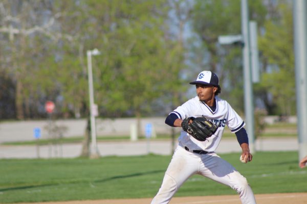Junior Matthew Robertson throws the ball to the hitter.