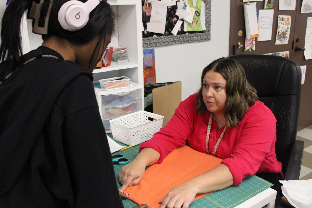Elizabeth Laley helps Tyler Croft on her Fashion 2 project on April 8.