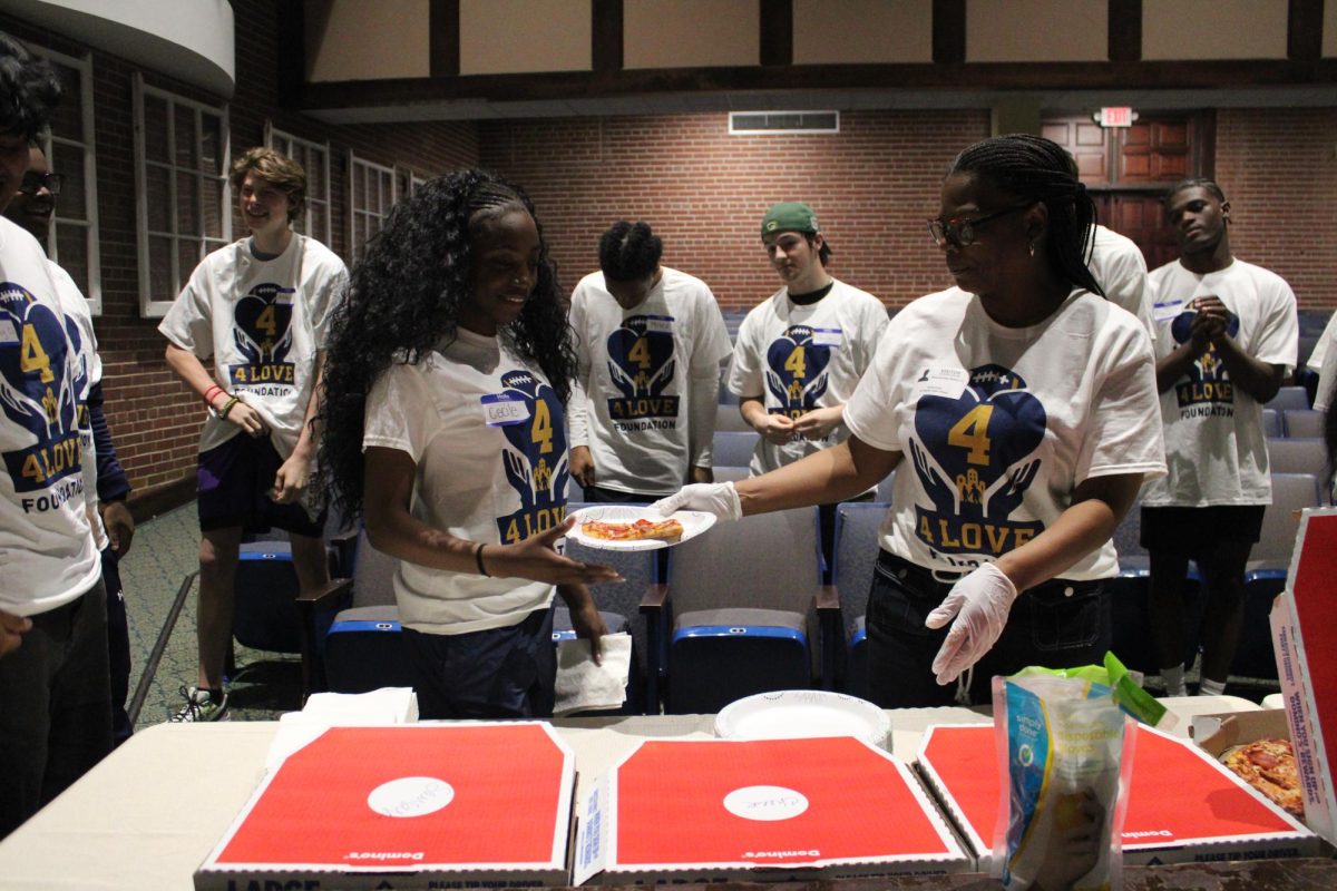 Cecil Puati receives food provided by the 4Love foundation.
