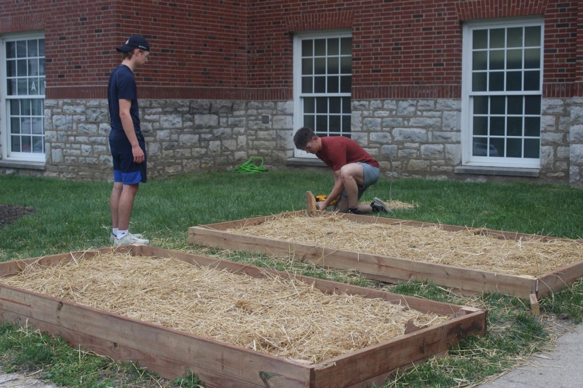 Hunter Broad and Jack Finch building the community club garden.