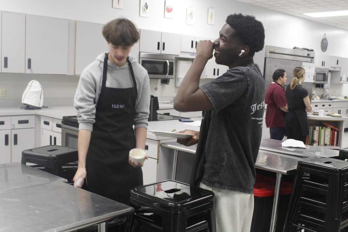 Seniors Sadock Espoire and Isaac Field cleaning dishes.