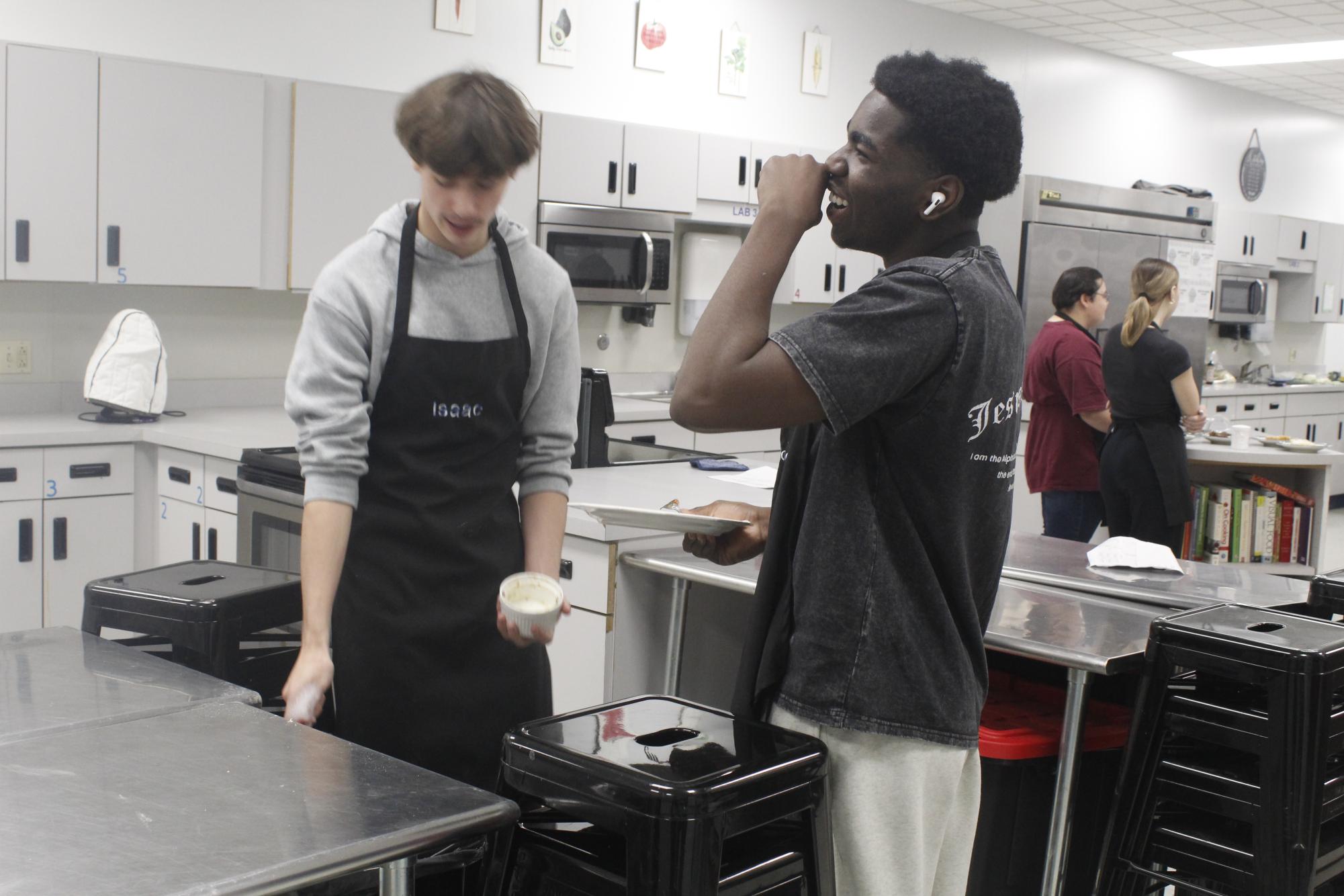 Seniors Sadock Espoire and Isaac Field cleaning dishes.