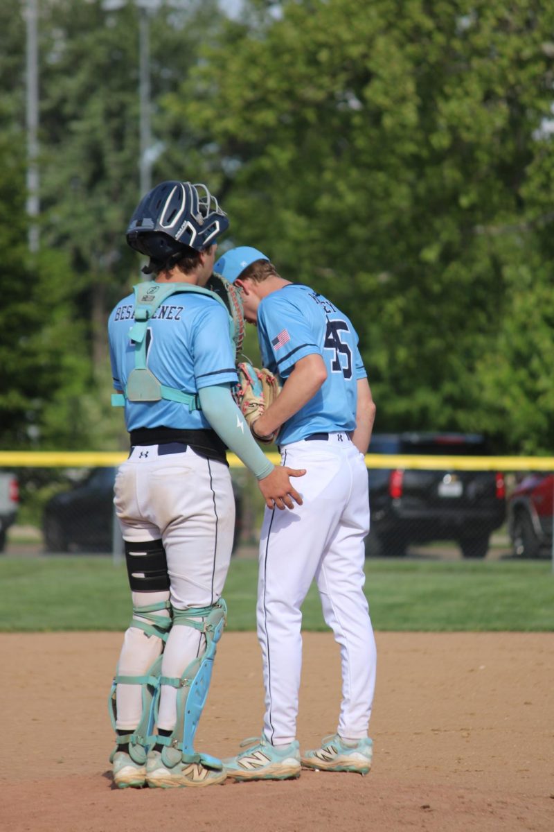 Nick Besancenez confers with Ethan Kimsey.