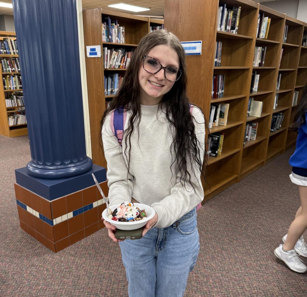 Senior Kylee Mize holding a treat.
