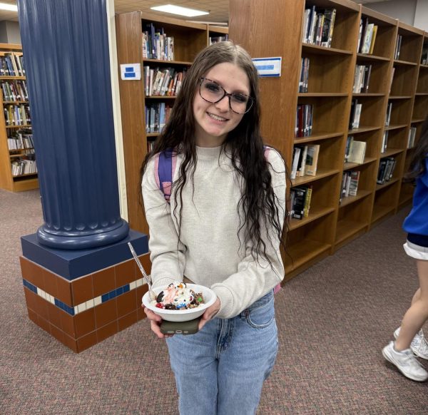 Senior Kylee Mize holding a treat.