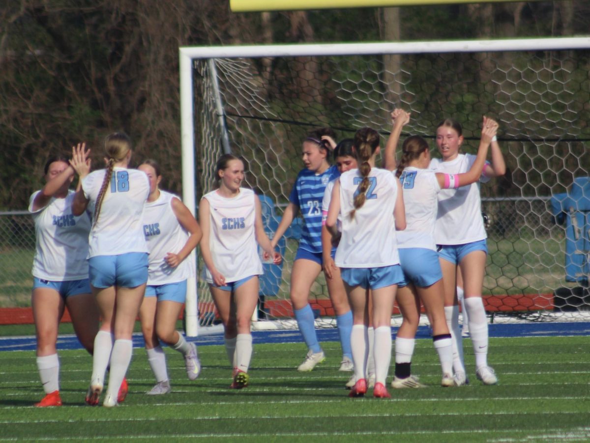 The team celebrates after a goal March 30 against Lutheran St. Charles. (Isabel Polezogopoulos)
