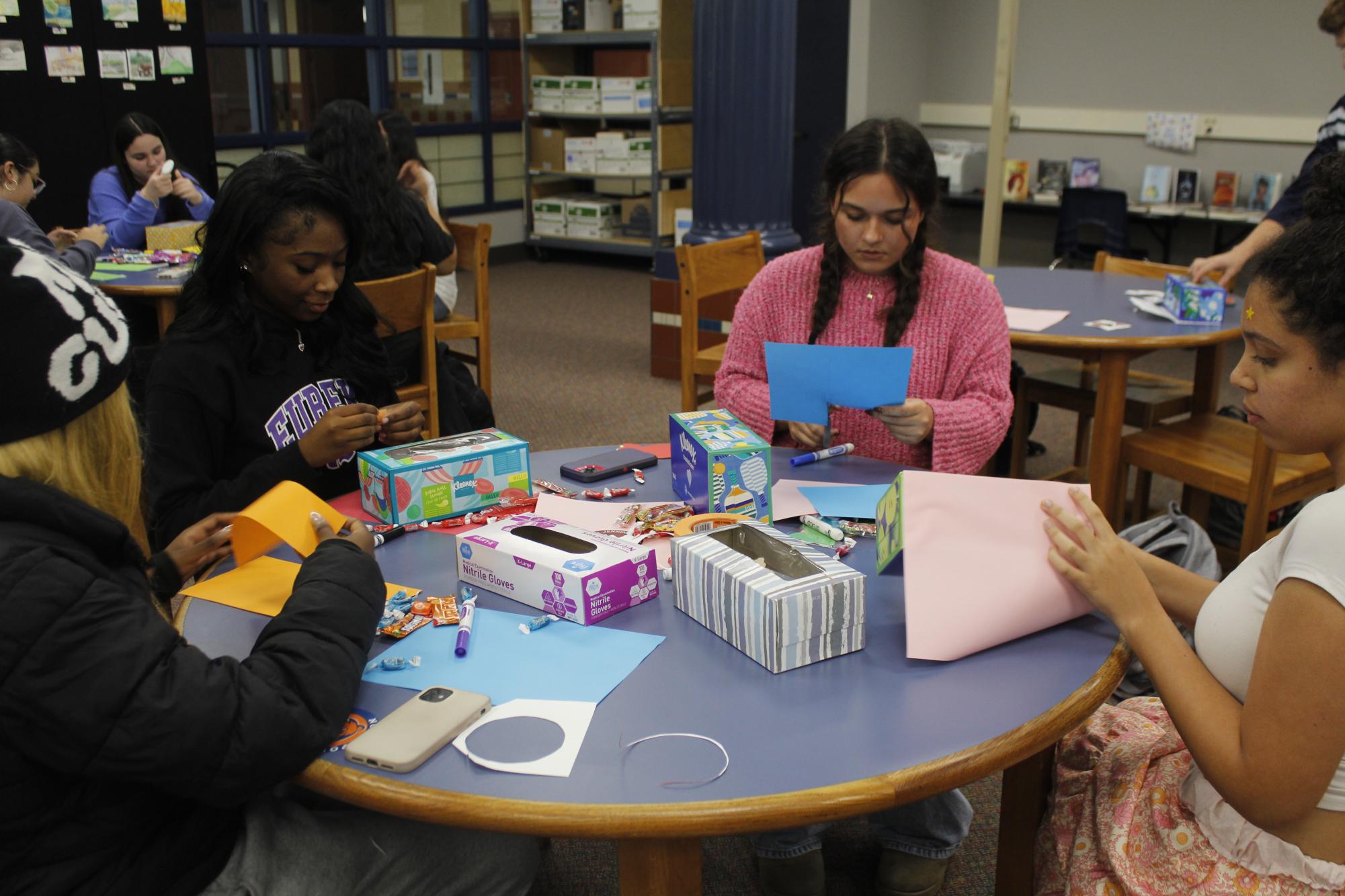 Lana Usery, Monica Ferguson, and Kennidi Crigler crafting items together