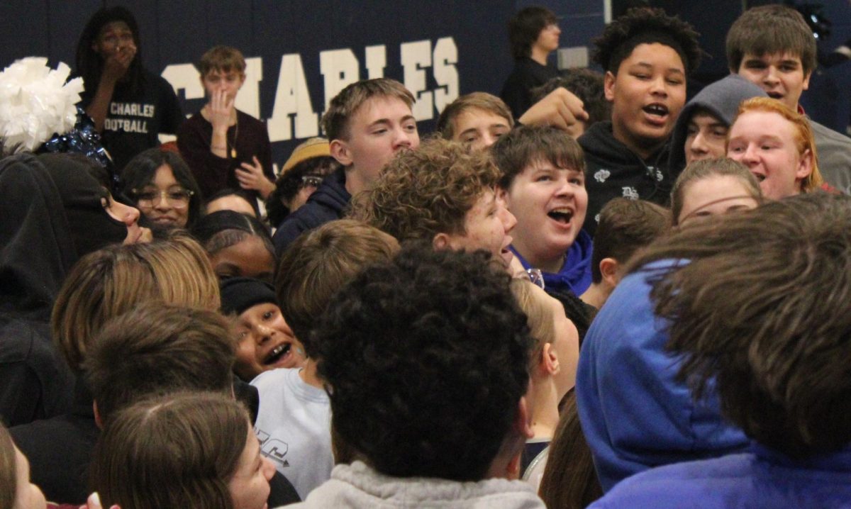 Freshman class gathers down at the bottom of the gym while jumping during the Turkey Tip-off Assembly.